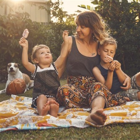 Picture of a woman with two children and a dog