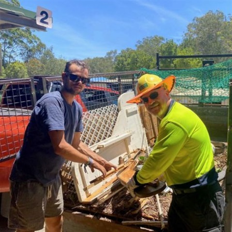 Picture of two people unloading a trailer