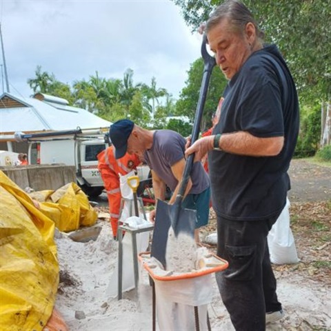 Picture of people filling bags with sand