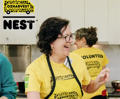 PICTURE OF A WOMAN LAUGHING WHILST COOKING