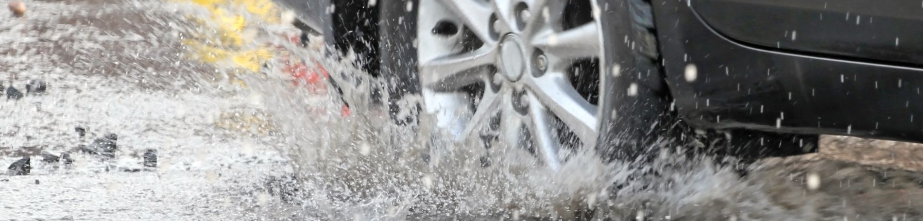 Picture of a car driving in the wet